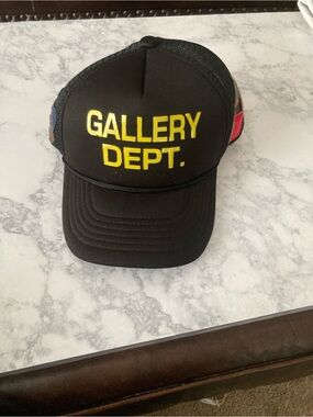 Gallery Dept Black Trucker Hat with Yellow Logo and Red/Blue Side Panels
